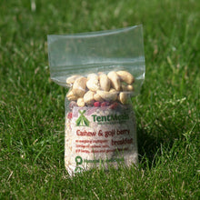 TentMeals Cashew and goji berry 500kcal breakfast in a field of grass