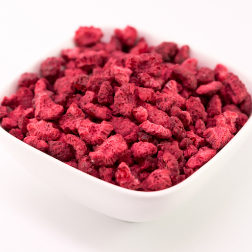 freeze dried raspberry pieces in a white bowl