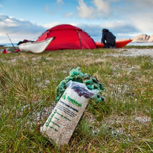 TentMeals Blueberry burst 800kcal breakfast in the foreground, with a tent and canoes in the background.