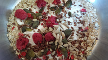 Close-up of a bowl containing the dried ingredients of a TentMeals Super seed and red berry breakfast.